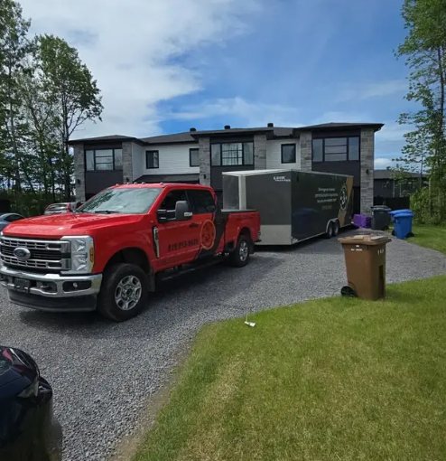 Davidson truck and enclosed trailer in front of houses