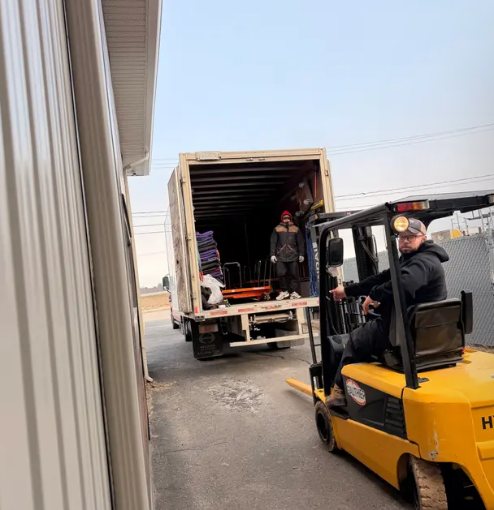 Forklift loading a delivery truck