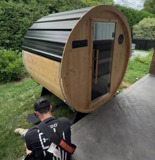 Barrel sauna moved by the Davidson crew