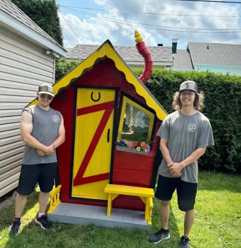Two Davidson movers beside a colourful kids’ playhouse