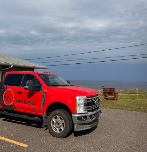 Red Davidson truck parked by the river